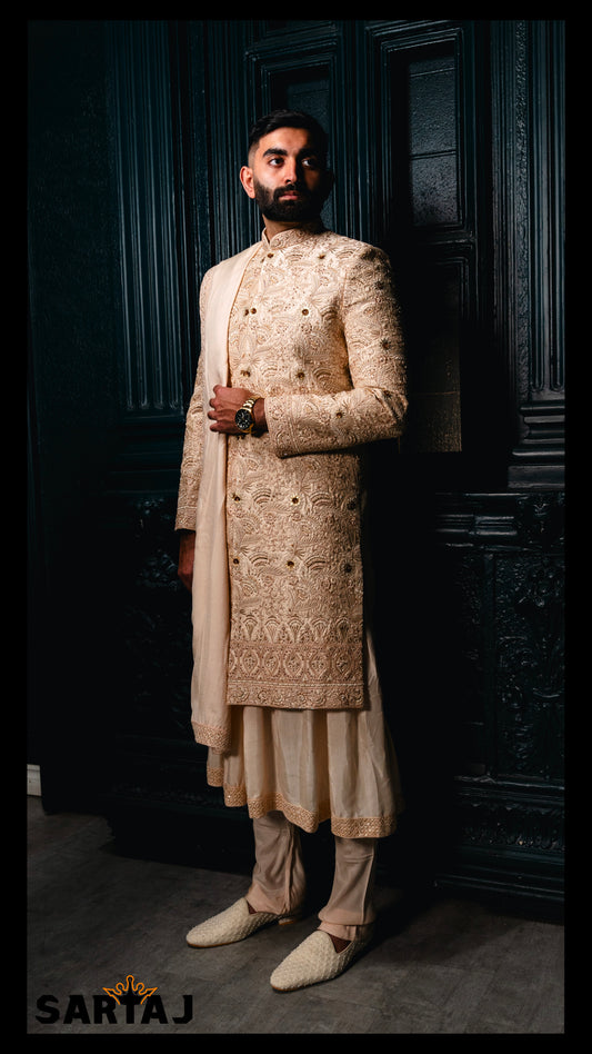 Champagne Dupion silk Mehr-e-Mardana groom sherwani featuring intricate resham embroidery, refined beadwork, and delicate stone accents, paired with a flowing Anarkali kurta, cotton lycra churidar, and a complementing shawl.