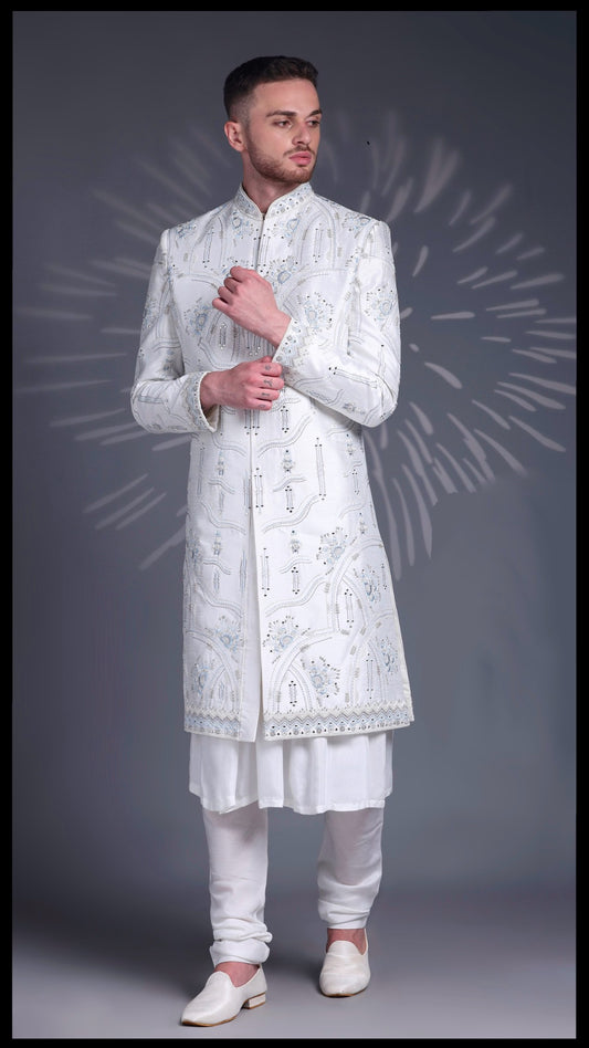 Off-white Noor-e-Riwaz groom sherwani in Dupion silk featuring intricate resham embroidery with sky blue threads, mirror accents, and tonal beadwork.
